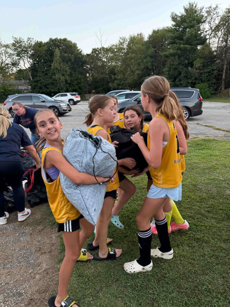 Volunteers smiling beside Go Green truck after successful fundraiser